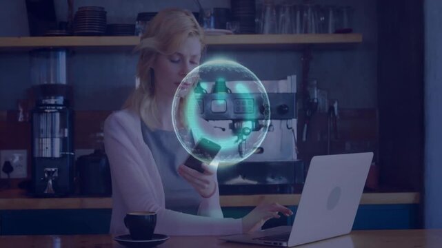 Woman at cafe counter, reaching for phone as holo orb appearing, typing on laptop syncing tech