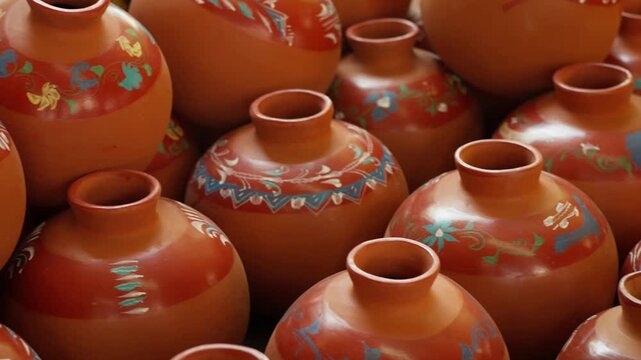 Rows of handmade terracotta pottery vases displayed at Mexican artisan craft market