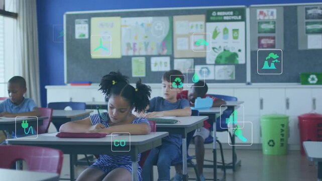 Classmates African American girl writing at front classroom desk with notebook and recycle bins