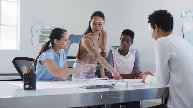 Team lead initiating design review by pointing papers on table, animated highlights showing edits