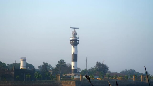 Indian Lighthouse in Moti Daman, a historic active lighthouse with a tall tower near the sea coast, captured in daytime with clear sky