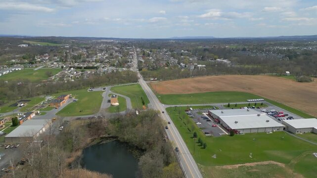 aerial, drone, road, field, countryside, landscape, rural, farm, meadow, nature, outdoors, scenery, daytime, travel, horizon, agriculture, green, grass, asphalt, winding, curve, perspective, view, hig