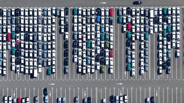 Aerial view of tightly packed cars in a lot, showcasing a dense arrangement of vehicles with various colors and textures, Sausheim, Grand Est, France.