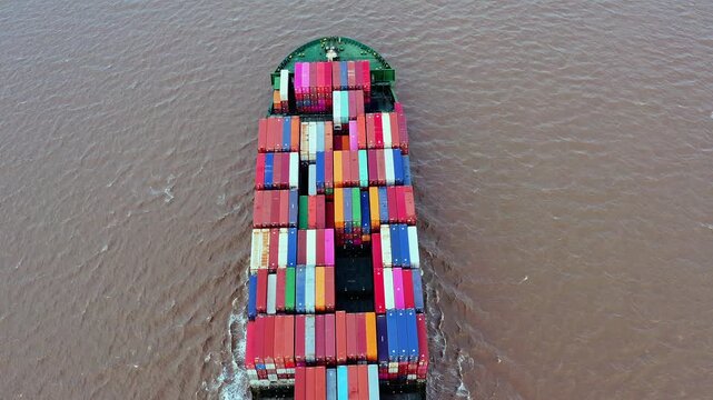 Aerial top down view of a large container ship sailing in the ocean for international logistics and maritime trade in Shanghai, China
