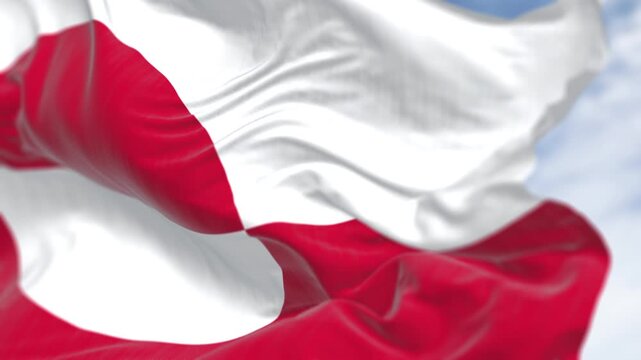 The flag of Greenland waving in the wind on a clear day. Greenland is the world's largest island. Seamless 3d render animation. Slow motion loop. Selective focus