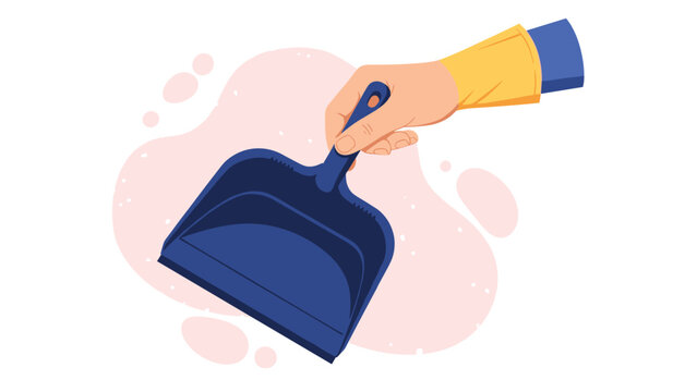 Close up view of a hand wearing a yellow cleaning glove holding a blue plastic dustpan against a soft pink abstract background.