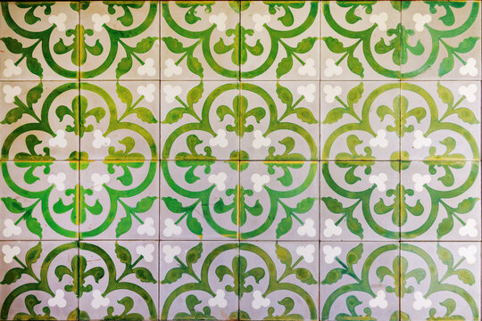 Old vintage cement floor tiles with green floral seamless pattern