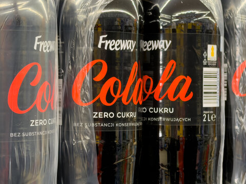 Szklarska Poreba, Poland - December 17, 2025: Plastic bottles of dark cola soft drink product, clearly labeled zero sugar, wrapped in transparent retail packaging