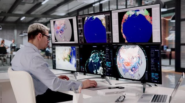 Meteorologist Studies Hurricane Patterns On Computer