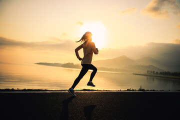 Fototapeta premium Fitness woman runner running at seaside