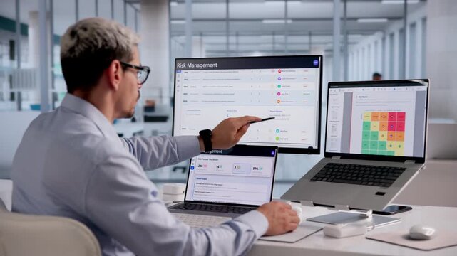 Business Analyst Studying Risk Factors On Computer