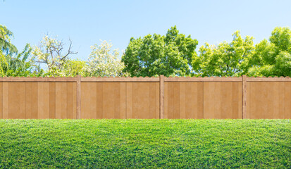Fototapeta premium grass in backyard and wooden garden fence in summer