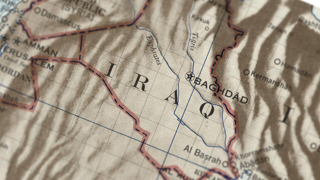 Macro close up of a vintage map highlighting Iraq, showcasing detailed cartography, major regions and cities, and classic antique textures ideal for travel, geography, and historical themes.