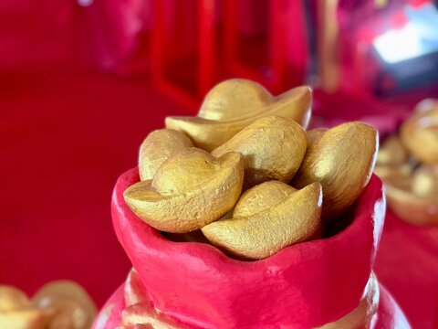 Collection of Chinese gold ornaments and decorations symbolizing prosperity and good fortune during Lunar New Year celebrations. Sudirman, Indonesia - January 29, 2026.