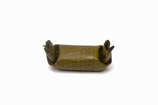 Traditional lemper Indonesian sticky rice roll filled with chicken, isolated on a white background. Simple food presentation with clean copy space, ideal for menus, packaging, and culinary concepts
