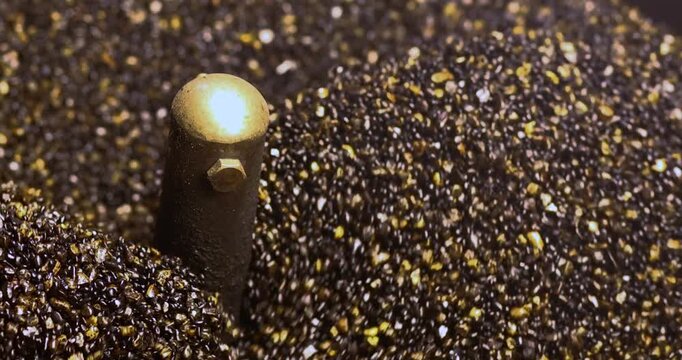 Roasting Sand for Chestnuts in a hot pan, close-up. rolling and heating. Ideal for food, snack, street food, and cozy winter concepts