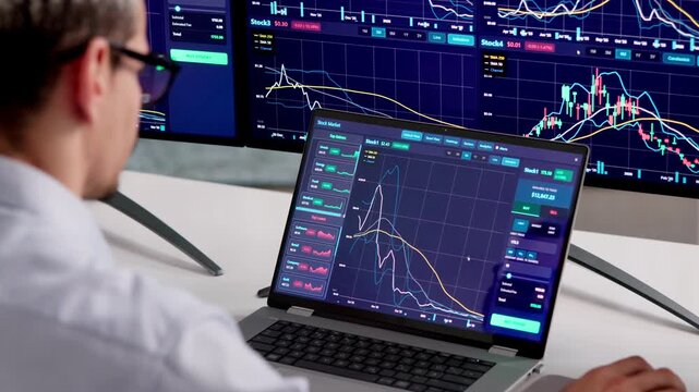 Stock Broker Watches Multiple Trading Screens While Working