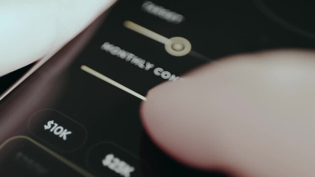 Close-up of user setting monthly contribution using a slider in a finance app