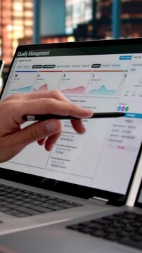 Quality Manager Reviewing Corrective Actions On Laptop