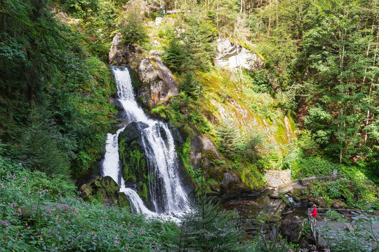 Woman standing by Triberg Waterfall in Black Forest Germany