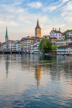 St. Peter and Fraum�nster churches by Limmat River at sunset in Zurich