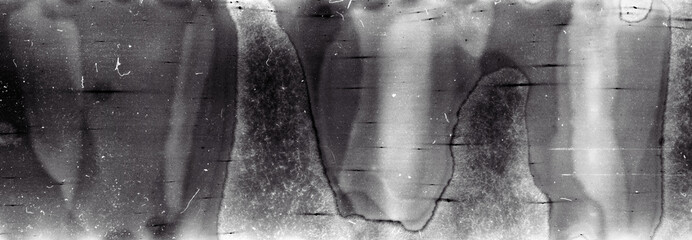Blank grained film strip texture background with heavy grain, dust and light leak