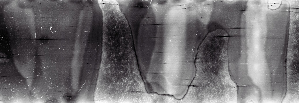 Blank grained film strip texture background with heavy grain, dust and light leak