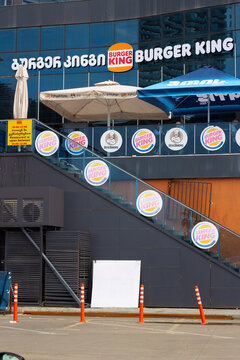 Batumi, Georgia - June 27, 2025: Vertical photo. Logo of chain Burger King, Usta Donerci on stairs of fastfood restaurant. Concept of dinner, lunch, pick up order, fast food, menu, eat, diet