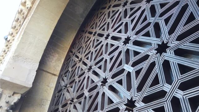 Islamic geometric wooden lattice arch in Cordoba mosque star pattern Spain
