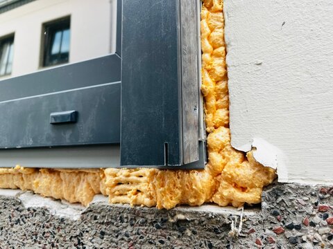 newly installed windows, construction foam used for insulating and securing window frames