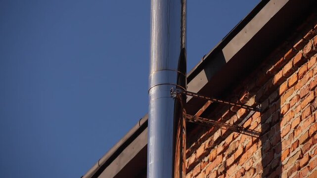 metal chimney from the wall of the house