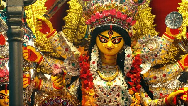 Close up of Durga statue with yellow tones during Durga Puja in Kolkata India