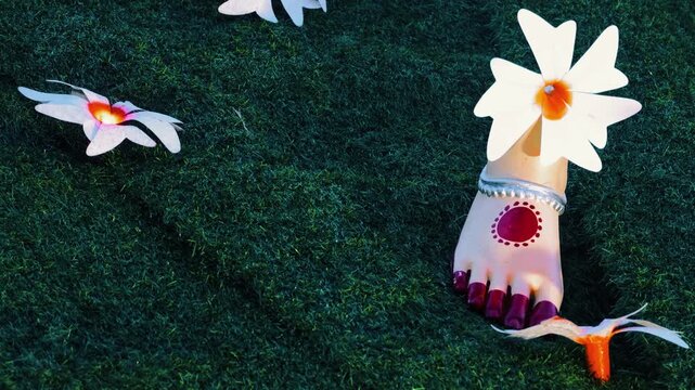 Close view of Goddess Durga feet decorated with harshingar flowers during Durga Puja in India
