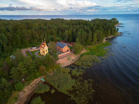 Aerial view of Russian Orthodox Skete with red brick architecture, Lake Ladoga shore, Konevets Island, Leningrad Region.