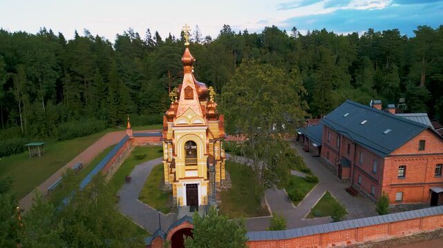 Aerial view of Russian Orthodox Skete with red brick architecture, Lake Ladoga shore, Konevets Island, Leningrad Region.