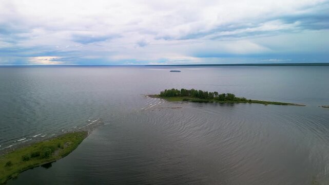 Nordic wild boreal forest coastline sand spit cape aerial panorama scenery.
