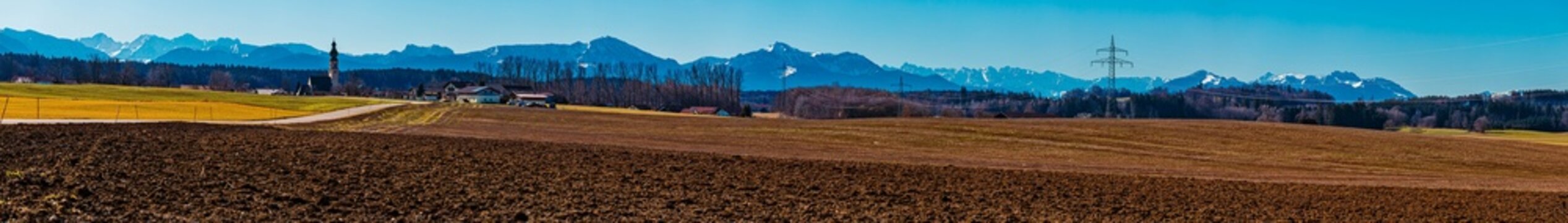 High resolution stitched alpine winter panorama with a church near Harpfetsham, Palling, Traunstein, Bavaria, Germany