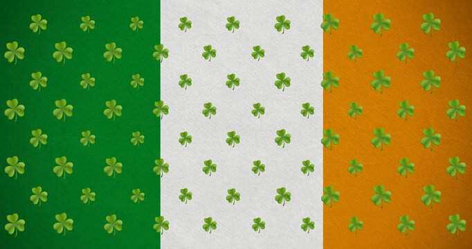 Digital animation of multiple clover leaves moving against irish flag