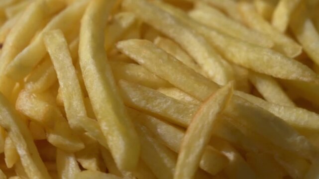 Macro close-up of rotating crispy french fries detail