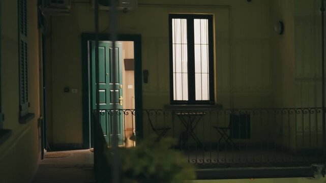 Milan Apartment: Open Door Revealing Warm Interior at Night
