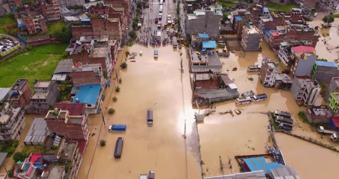 Aerial drone footage of traffic and buildings submerged in floodwaters across Banepa Nepal, showing the severe blockage of the vital Araniko highway after heavy monsoon rainfall.