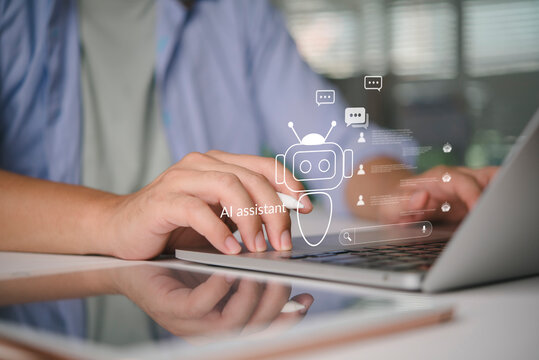 Man using laptop and stylus with virtual AI assistant chatbot hologram. Concept of artificial intelligence for customer service support, automated communication, online helpdesk and smart technology.
