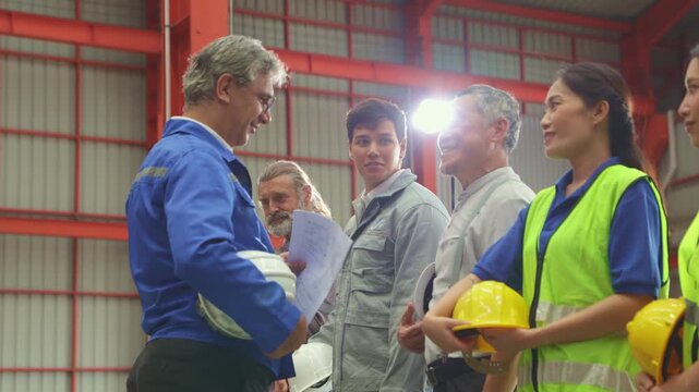 Factory supervisor delivered an inspirational speech before employees began their duties in their departments and workstations on the metal sheet production line.