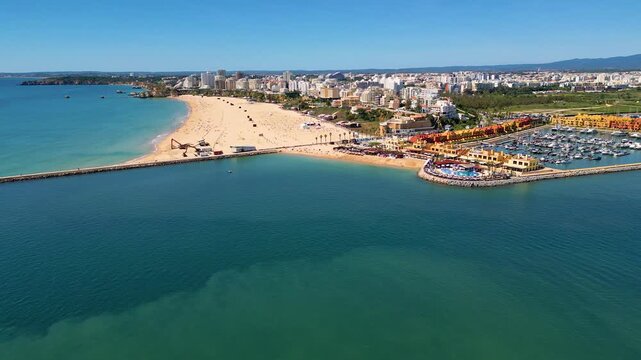 Aerial View on Beach and Marina of Portim&atilde;o Algarve Portugal, flying forwards