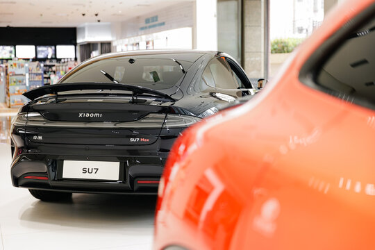 Guangzhou, China - December 22, 2025: black electric crossover xiaomi car SU7 vehicle in showroom