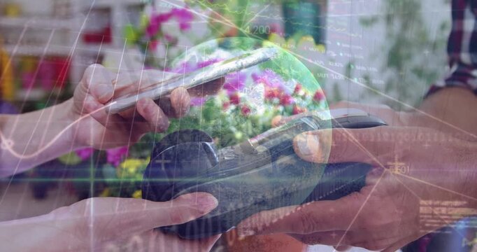 A customer is seen making a payment through their smartphone in a flower shop