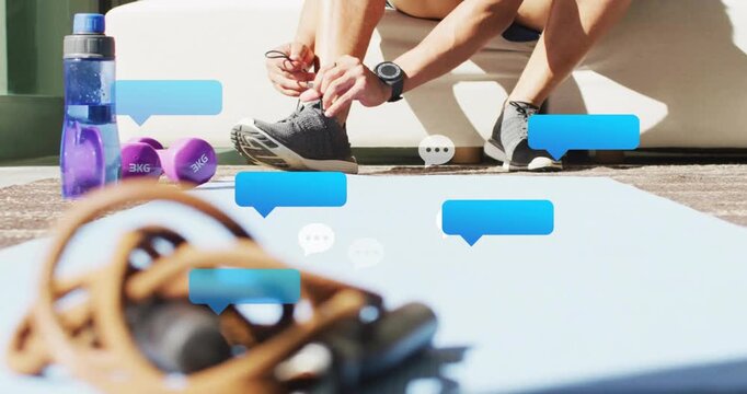 Man reaching and tying shoe laces on mat, animated speech bubbles drifting, signaling workout start