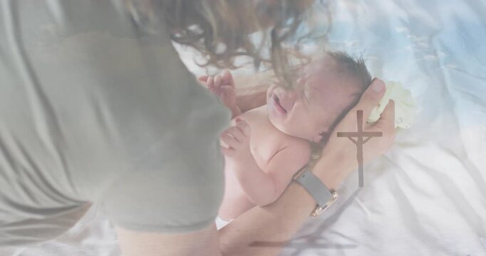 Mom reacting to baby crying holding head, patting calming on sheet parenting cross overlay hovering