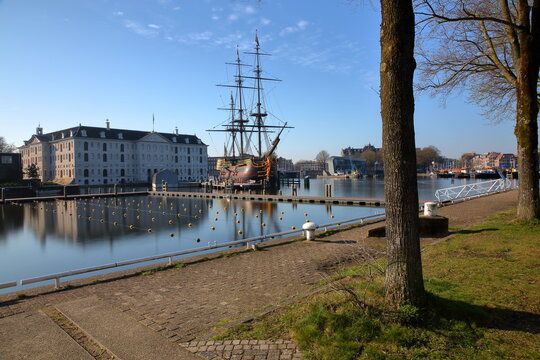 AMSTERDAM, NETHERLANDS - MARCH 04, 2026: Het Scheepvaart Museum (National Maritime Museum) located in Oosterdok neighborhood and viewed from a popular outdoor canal swimming (Marineterrein)