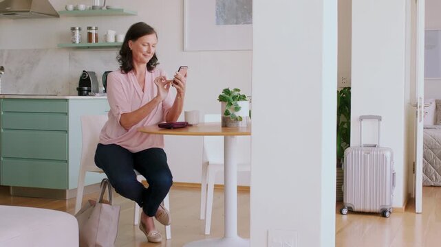 Woman, phone and credit card in hotel with payment, travel expense or eft transaction for holiday cost. Mature person, tech and digital banking in accommodation with website fees or bill for vacation